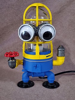 Steampunk style MINION Lamp made with black iron pipe and Vandal proof security light