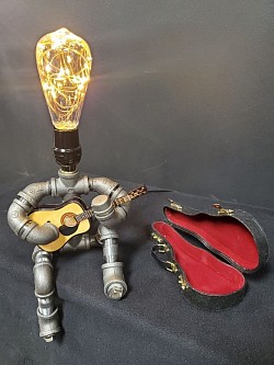 Steampunk style GUITAR player Guy made with black iron pipe and includes a 7 inch replica accoustic guitar with case